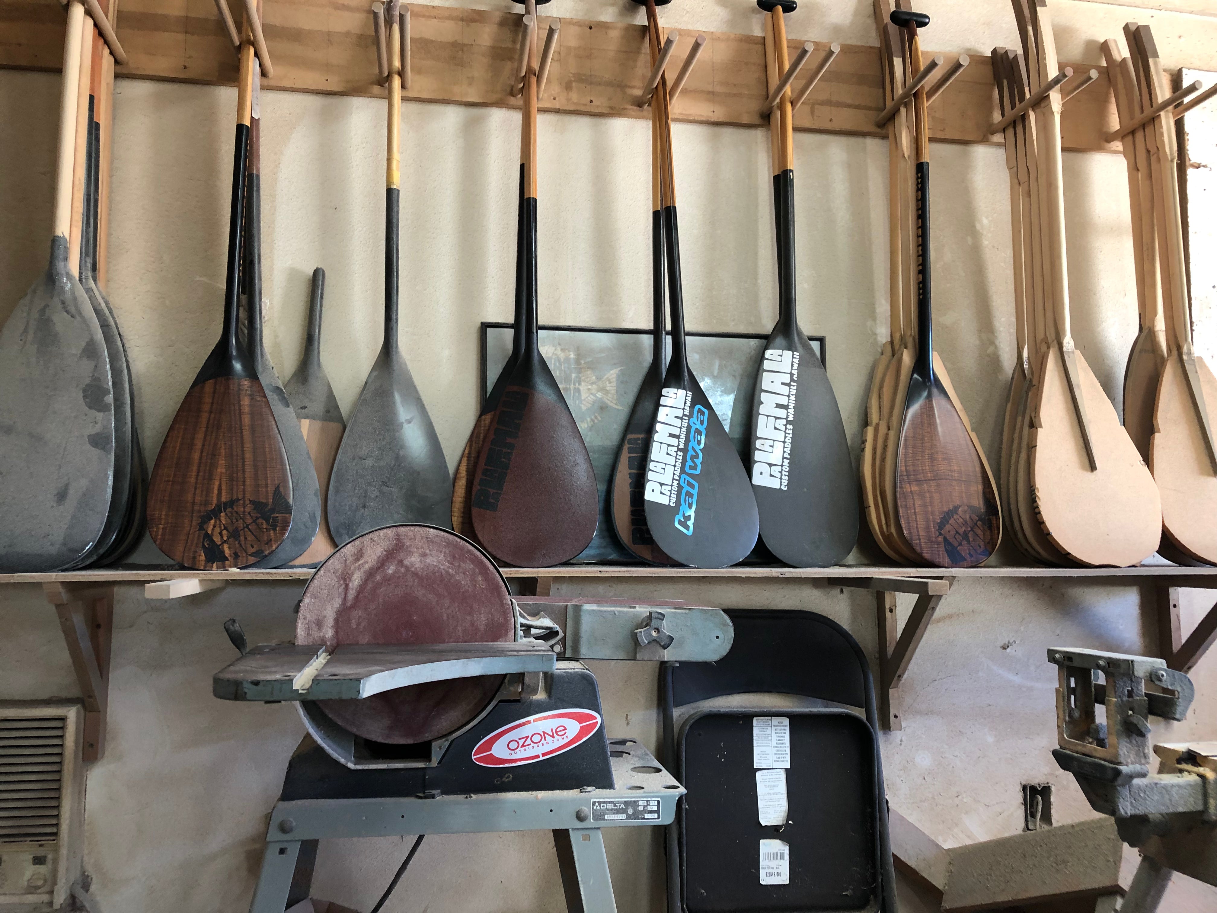 collection of paddles in a workshop
