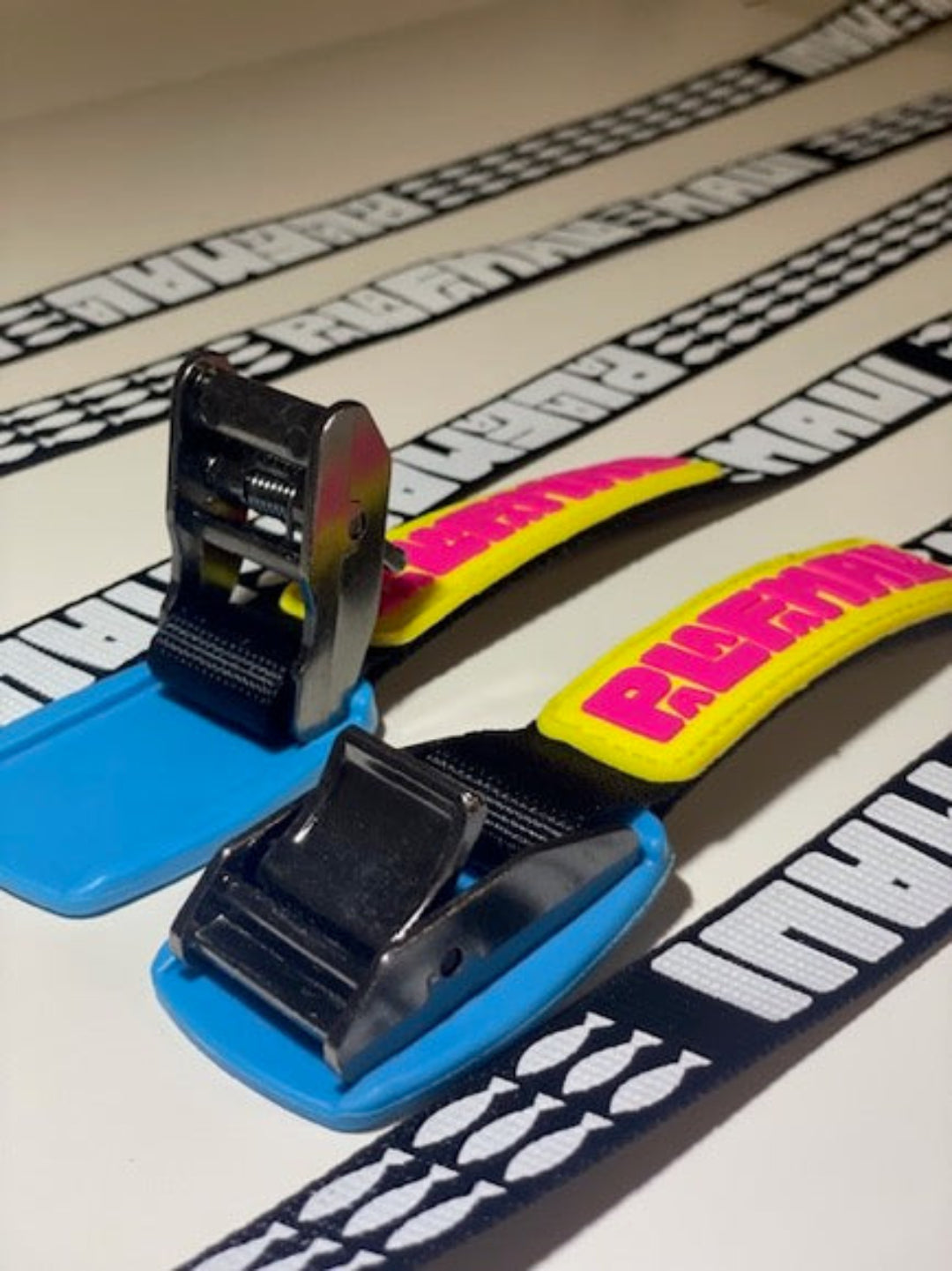 heavy duty tie down straps with in yellow and pink PALAFAMALA rubber lettering
