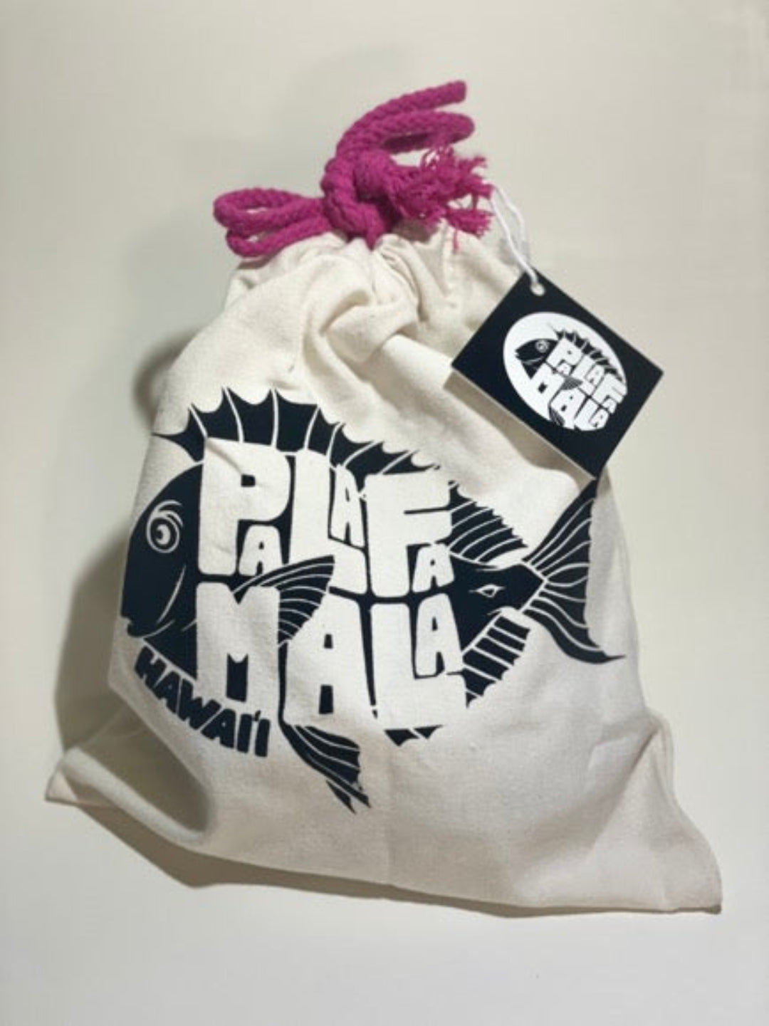 White drawstring bag with black graphics and text, featuring a brand tag on a light gray background.