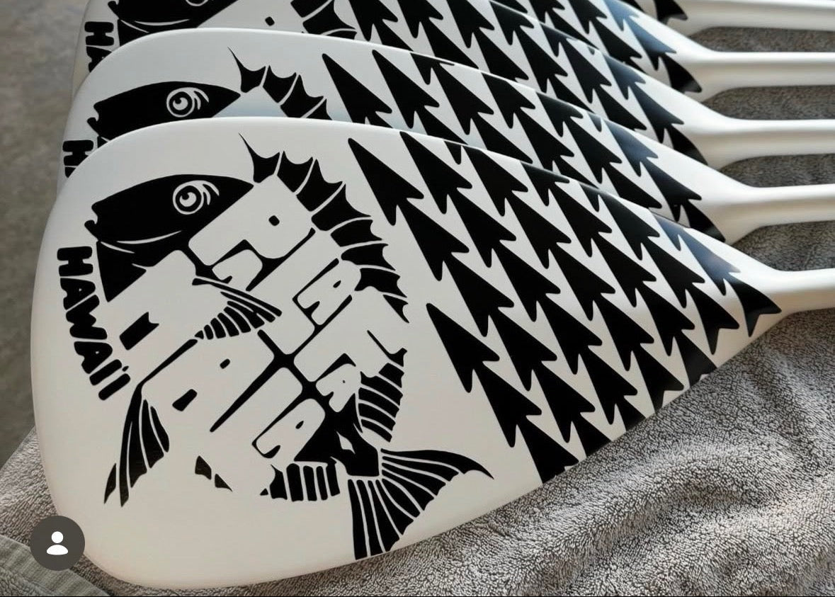 white paddle with pala logo and tribal arrows